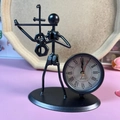 Vintage black iron desk clock featuring a violinist figurine and Roman numerals - C65 Violin Clock