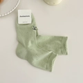 Calze verde chiaro in cotone pettinato con delicato ricamo a fiocco nero - Taglia unica / Verde Latte