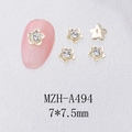 Macro shot of 7x7.5mm gold metal five-petal flower nail charms with clear gems - Gold Camellia Rhinestone (A494)