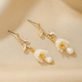 Elegant 18K gold flower earrings with marquise zircon and pearl drop on beige fabric - Flower Pendant Earrings