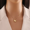 Golden 3D bubble letter H pendant necklace with beaded chain on female model - Letter H