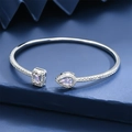 Elegant adjustable silver bangle featuring a teardrop and rectangle pink stone setting - Pink