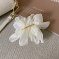 Detail of elegant white chiffon flower hair clip with gold metal center and soft texture - Fairy Rice White