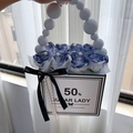 Detail of luxury rose gift box with blue artificial flowers and pearl handle decoration - Twilight Blue Smoke