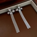 Detail of silver long tassel earrings with flower studs in a dark brown jewelry box - Silver Earring Post Style / Silver