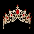 Close-up of golden bridal crown featuring large red gemstones and clear rhinestones - Large V-Shaped Gold With Red Rhinestone