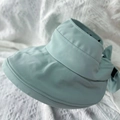 Light blue wide brim sun visor hat with decorative bow on white knit texture - Sun Hat Light Green