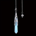 Macro view of opalite hexagonal prism pendant with silver filigree metal cap detail - Opal