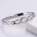 Detailed view of silver geometric cuff bracelet with sparkling zircon accents on stone - Steel