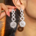 Elegant silver long drop earrings with shiny crystal pavé circles and sparkling finish - Silver Rings and Disk Long Earrings