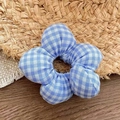 Detailed view of a blue and white gingham fabric flower scrunchie on a natural wood surface - Blue Checkered (Approx. 10.5cm)