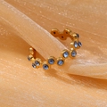 18k vergulde roestvrijstalen ring met blauwe zirkoon op een roze glanzende stof - Eén maat / Blauwe Strass