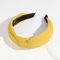 Cross-knot knitted headband in vibrant yellow fabric with a soft black inner lining - Ginger Yellow
