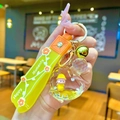 Orange acrylic heart-shaped liquid keychain with raincoat figure and bell detail - Yellow Hat Girl Heart Perfume Bottle