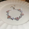 Detail view of pink heart gemstones and adjustable silver chain on a white ceramic plate - Pink and White Heart Bracelet (3#)