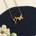 Golden stainless steel necklace featuring a lowercase p pendant with butterfly silhouette - Gold P