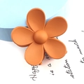 Macro detail of the orange matte flower hair claw clip with a frosted texture finish - Large Flower Style / Orange