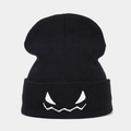 Close-up of spooky monster face embroidery on black cuffed winter beanie hat - Black