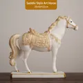 Modern white ceramic horse figurine with gold saddle accents on wooden tabletop - Saddle-shaped Horse Figurine 8731