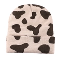 Close-up of the fine knit texture and stylish cow print pattern on this winter beanie - Khaki Brown