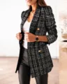 Detailed close-up of black and white tweed fabric with textured weave and gold buttons - S / Tops / Black