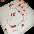 Detail of multi-layered gold necklace featuring red crystal beads and white pearls - Necklace-Red-White