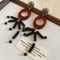 Detail of vintage drop earrings with red resin hoops and black beaded tassels on linen - Earrings - Gold Black Coffee (With 925 Silver Pin)