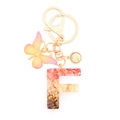 Resin letter F keychain with pink glitter gold foil and butterfly charm accessory - Letter F