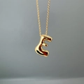 Close-up of golden letter E pendant on a fine O-chain with polished metallic finish - Letter E Single Pendant
