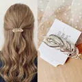 Elegant gold feather hair clip with white pearls and rhinestones on a spring barrette - Pearl Rhinestone Peacock Feather Spring Clip