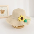 Detail of children's straw hat featuring a decorative fabric sunflower and lace trim. - Hat / Beige
