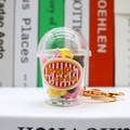 Detailed close-up of a mini 3D popcorn cup keychain with gold chain and colorful star beads - Popcorn-Orange