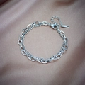 Bracciale a doppia catena in acciaio al titanio argento su sfondo in seta champagne - Argento