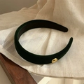 Deep green velvet sponge headband with golden button detail on beige fabric background - Dark Green