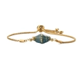 Adjustable gold chain bracelet with a blue conch ceramic charm on a white background - Blue Spotted + Stainless Steel