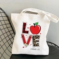 Off-white cotton tote bag featuring creative LOVE print and Teacher Life slogan - Teacher Life Creative LOVE
