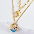 Collier double rang doré océan avec pendentifs dauphin et palmier sur fond blanc pur - Collier