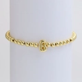Elastic 18k gold plated beaded bracelet featuring a glossy letter B balloon charm - Gold B
