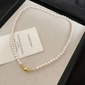 Detail of elegant white round pearls and a golden spherical clasp on a beige fabric tray - 87# Necklace - Gold - White - 6mm (genuine Gold Plated)