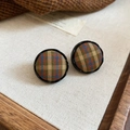 Macro shot of British style checkered fabric stud earrings with elegant black borders - Silver Needle Round Studs / Green Plaid