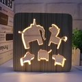 Detail of warm LED light shining through hollowed animal patterns in square wooden lamp - Animals/15cm