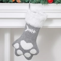 Close-up of grey knit Christmas stocking with white claw pattern and plush faux fur trim - Grey Paw Stocking