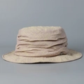 Detailed close-up of a distressed linen bucket hat with layered texture design - M (56-58cm) / Beige