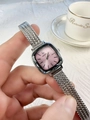 Detail of pink square dial watch with silver mesh band against a white textured fabric - Silver Pink Dial