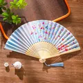 Classic light blue folding fan with pink cherry blossoms and a blue silk tassel detail - 15 Cyan Cherry Rain