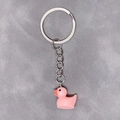 Detail of a bright pink resin duck keychain with a silver-colored metal ring and chain - 28mm Ring / Pink