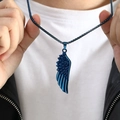 Close-up of a blue feather wing pendant on a chain worn with a black leather jacket - Pendant Only (No Chain) / Blue