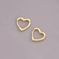 Macro shot of polished 18K gold heart-shaped metal earrings with minimalist geometric design - Large Heart Pendant / Gold
