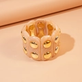 Macro detail of acrylic stretch bracelet with marble texture and gold metal studs - Brown