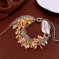 Detailed macro view of multi-layer leaf tassels and smooth metallic plate on chain bracelet - Gold/Silver (Gold Leaf Silver Chain)